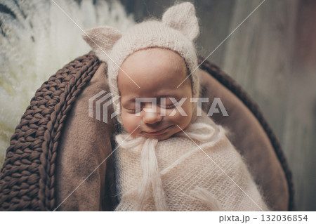 A newborn baby is wrapped in diapers with a wool cap in a basket. Swaddling, maternity hospital, family, ivf, life planning, parenting. A mother's love for her child. Baby food. High quality photo A newborn baby is wrapped in diapers with a wool cap in a basket. Swaddling, maternity hospital, family, ivf, life planning, parenting. A mother's love for her child. Baby food. High quality photo 132036854