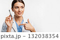 A female doctor holds and points to an insulin pen for diabetes treatment. Healthcare professional explaining a medical device on a white background with copy space A female doctor holds and points to an insulin pen for diabetes treatment. Healthcare professional explaining a medical device on a white background with copy space 132038354