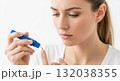 Woman performing a blood glucose test on her finger with a lancet device. Patient self-monitoring for diabetes management. Healthcare and medical concept Woman performing a blood glucose test on her finger with a lancet device. Patient self-monitoring for diabetes management. Healthcare and medical concept 132038355