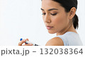 A young woman gives herself an insulin injection with a pen in her arm. Diabetic patient managing a chronic illness. Medical self-care concept with copy space A young woman gives herself an insulin injection with a pen in her arm. Diabetic patient managing a chronic illness. Medical self-care concept with copy space 132038364