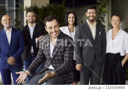 Happy business leader talking, sitting in front of smiling team on meeting Happy business leader talking, sitting in front of smiling team on meeting 132038460