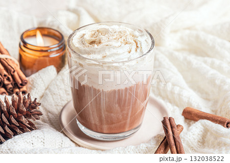 Cozy winter or Christmas concept with coffee (Eggnog Latte) and candle 132038522