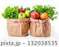 Paper grocery bags filled with fresh vegetables on white background 132038535