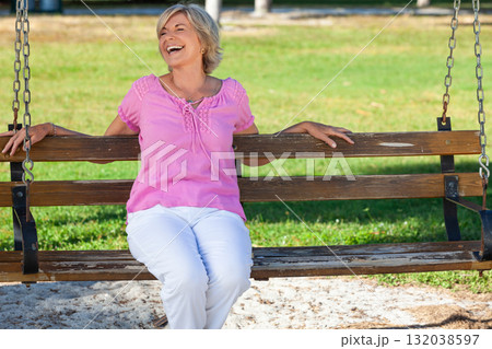 Portrait Happy Senior Woman Sitting Outside on a Bench Laughing Portrait Happy Senior Woman Sitting Outside on a Bench Laughing 132038597