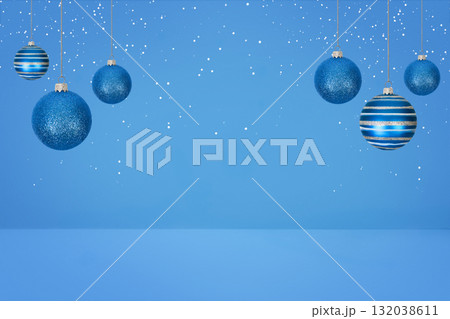 Christmas tree baubles on blue background with white snow. Festive winter holiday background. Design with copy space for greeting card, text, advertising, banner, invitation 132038611