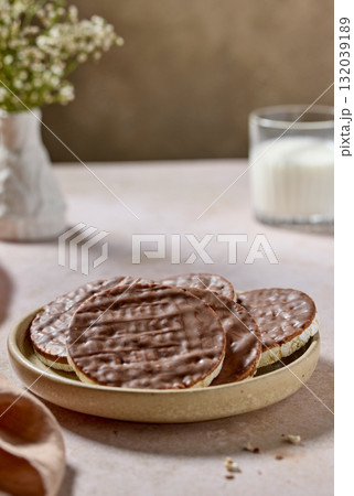 plate of rice galettes cakes cookies covered with milk chocolate 132039189