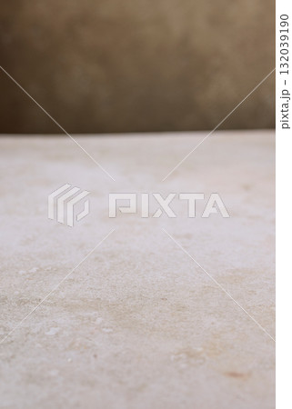 beige table and brown wall background 132039190