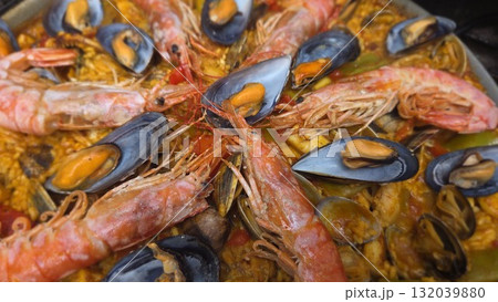 Traditional spanish paella with seafood shrimp and mussels. Close-up. Typical cuisine of Spain. Valencian cuisine. Stage of cooking paella. Ingredients for paella Traditional spanish paella with seafood shrimp and mussels. Close-up. Typical cuisine of Spain. Valencian cuisine. Stage of cooking paella. Ingredients for paella 132039880