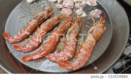 Traditional spanish seafood paella with shrimp and ingredients in large pan. Typical cuisine of Spain. Valencian cuisine. Stage of cooking paella. Ingredients for paella 132039960