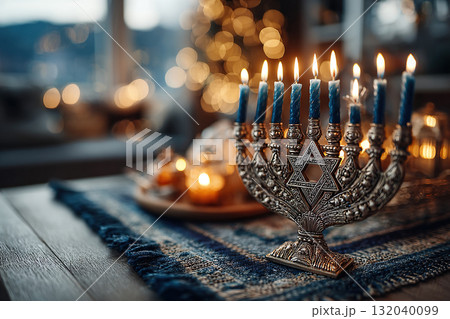 Nine candles burn in a menorah on a table. Blurred bokeh background. Hanukkah background. Nine candles burn in a menorah on a table. Blurred bokeh background. Hanukkah background. 132040099