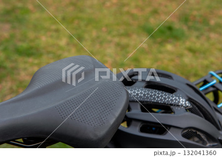 Black cycling helmet on the bicycle rack 132041360