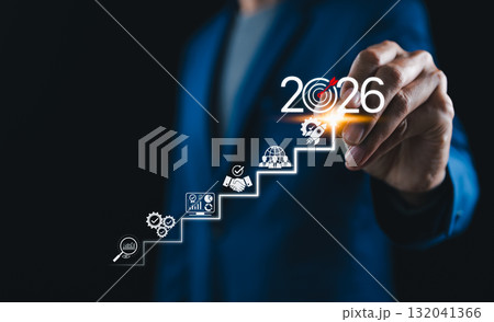 2026 New Year Business Goals Concept. Businessmen point to 2026 on a staircase, steps toward achieving business goals, growth, and success in the new year. Planning and challenge, investors target, 132041366