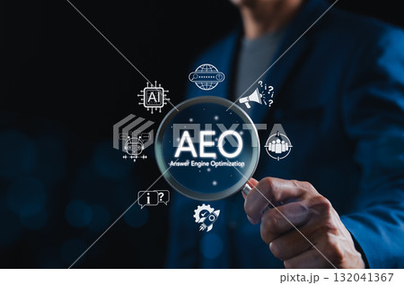AEO Answer Engine Optimization Strategy Concept. Businessman holding magnifying glass with AEO icons, representing artificial intelligence, chatbots, search optimization, and marketing strategy. AEO Answer Engine Optimization Strategy Concept. Businessman holding magnifying glass with AEO icons, representing artificial intelligence, chatbots, search optimization, and marketing strategy. 132041367