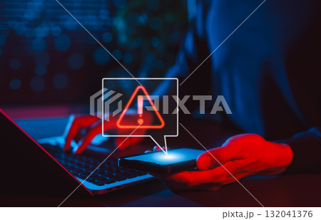 Mobile Security Alert and Cyber Threat Notification. Man holding smartphone with red warning sign and exclamation mark, symbolizing secure, system errors, hacking alerts, and online data protection. 132041376