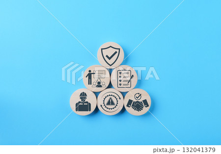 Work Safety and Compliance Risk Management Concept. Wooden blocks with icons of safety, checklist, training, handshake, compliance, risk warning, symbolizing workplace safety, risk, compliance process 132041379