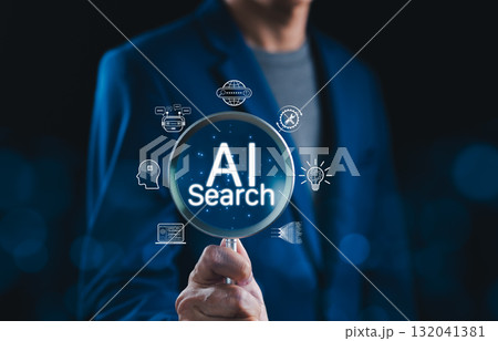 AI Search Engine Technology and Innovation Concept. Businessman holding magnifying glass with AI search text, icons of artificial intelligence, chatbot, big data, representing AI-driven search tech. 132041381