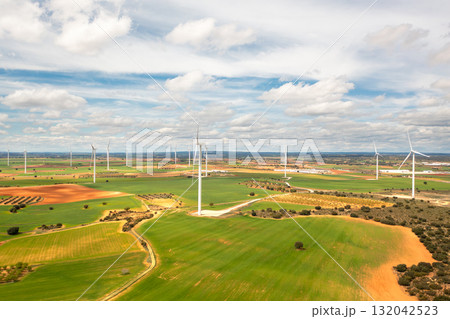 Aerial view of wind turbines in expansive green 132042523