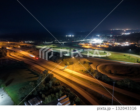 Vehicles are traveling along the illuminated roads of a highway interchange 132043316