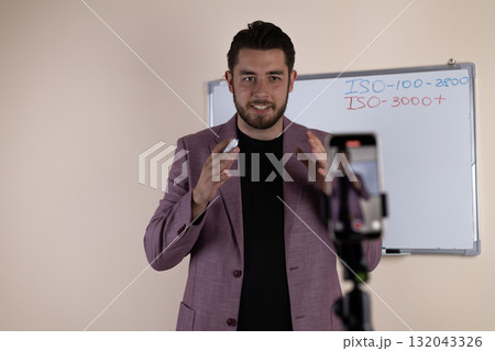 A journalist is preparing to record a video report on his smartphone 132043326