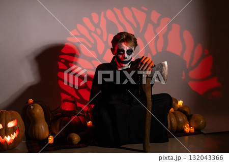 Man in black suit menacingly brandishing a knife 132043366