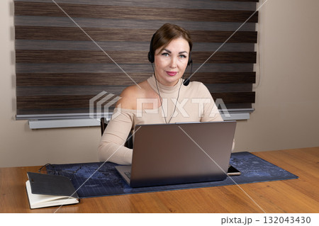 The woman is working on a computer, possibly conducting a remote interview 132043430