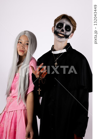 models are posing for a Halloween-themed photo,with one person wearing a scary models are posing for a Halloween-themed photo,with one person wearing a scary 132043449