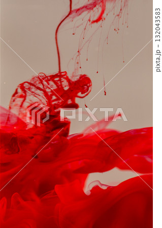 Vibrant red ink swirling in water 132043583