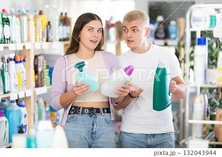 Young couple choosing spray and detergent in department store 132043944