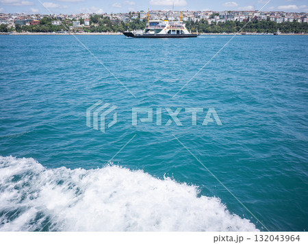 【トルコ】イスタンブールのボスポラス海峡を航行する船の上から望む白波と対岸の街並み 132043964