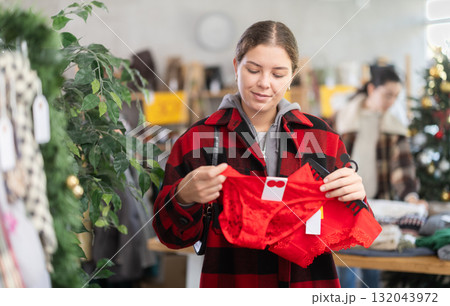 European girl near showcase pick out and buying traditional red ladys panties, New Year eve European girl near showcase pick out and buying traditional red ladys panties, New Year eve 132043972