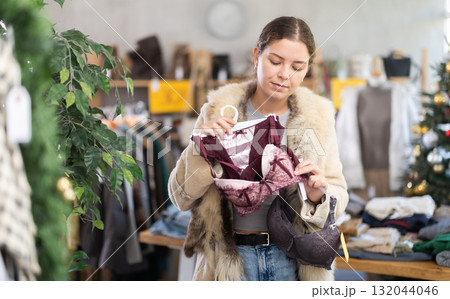 Young girl near showcase pick out and buying ladys bra, New Year eve 132044046