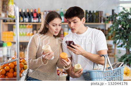 Couple man and woman scanning qr code for sauces Couple man and woman scanning qr code for sauces 132044176