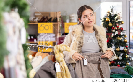 Woman choosing warm pants in the store 132044315