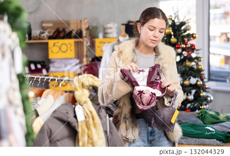 Young girl near showcase pick out and buying ladys bra, New Year eve Young girl near showcase pick out and buying ladys bra, New Year eve 132044329