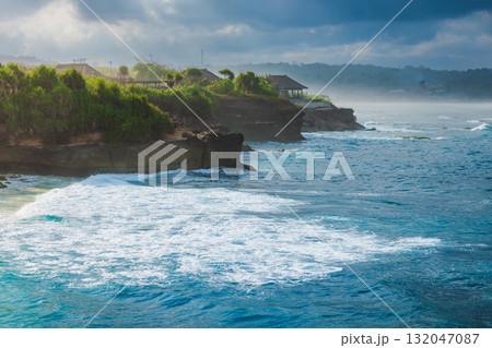Tropical coastline with ocean and cloudy sky 132047087
