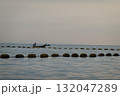 Silhouette of Fisherman on Boat in Calm Waters 132047289