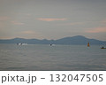 Jet Skis and Kayak on the sea with a chain of hills in the background 132047505