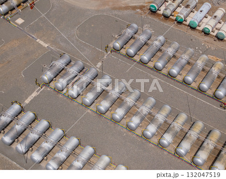 Industrial oil storage tanks at outdoor facility during daytime Industrial oil storage tanks at outdoor facility during daytime 132047519