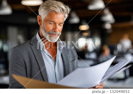 Professional economist analyzes reports in minimalist office Professional economist analyzes reports in minimalist office 132049052