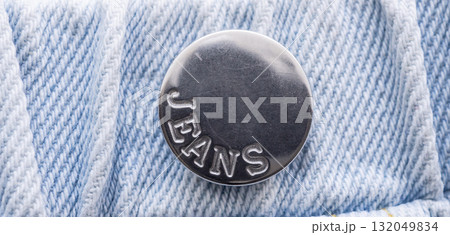 Old metal button closeup on blue jeans 132049834