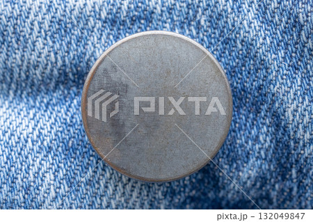 Old metal button closeup on blue jeans Old metal button closeup on blue jeans 132049847