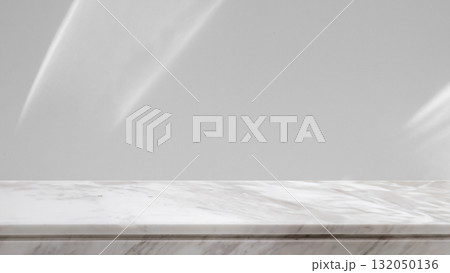 Marble table top with abstract shadow drop on white wall background for mockup product display Marble table top with abstract shadow drop on white wall background for mockup product display 132050136