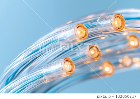 Bright Transparent LED Lights on Flexible Wire Against Soft Blue Background Bright Transparent LED Lights on Flexible Wire Against Soft Blue Background 132050217