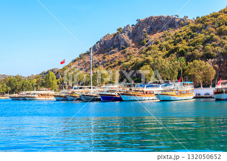 Port with tourist boats on the Mediterranean sea coast in Turkey 132050652