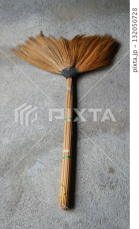 Natural Grass Broom on Textured Concrete Floor, Traditional Asian Broom Natural Grass Broom on Textured Concrete Floor, Traditional Asian Broom 132050728
