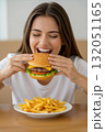 ハンバーガーを頬張る女性 132051165