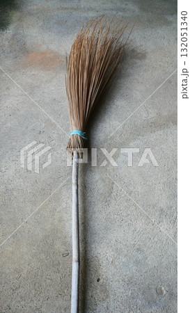 Traditional Asian Coconut Leaf Midrib Broom on Concrete Floor Traditional Asian Coconut Leaf Midrib Broom on Concrete Floor 132051340