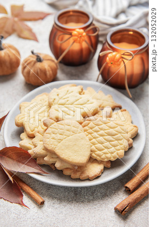 Autumn cookies on plate with cinnamon and fall decor 132052029