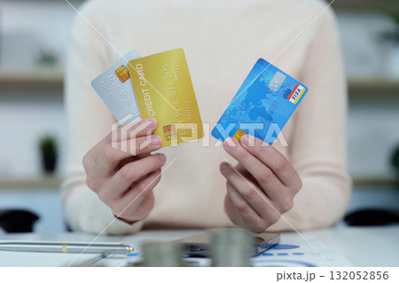 Credit Management. Woman holding multiple credit cards, showcasing financial options. Credit Management. Woman holding multiple credit cards, showcasing financial options. 132052856