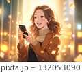 嬉しそうな笑顔でスマホを持つ若い女性と金色の光 132053090